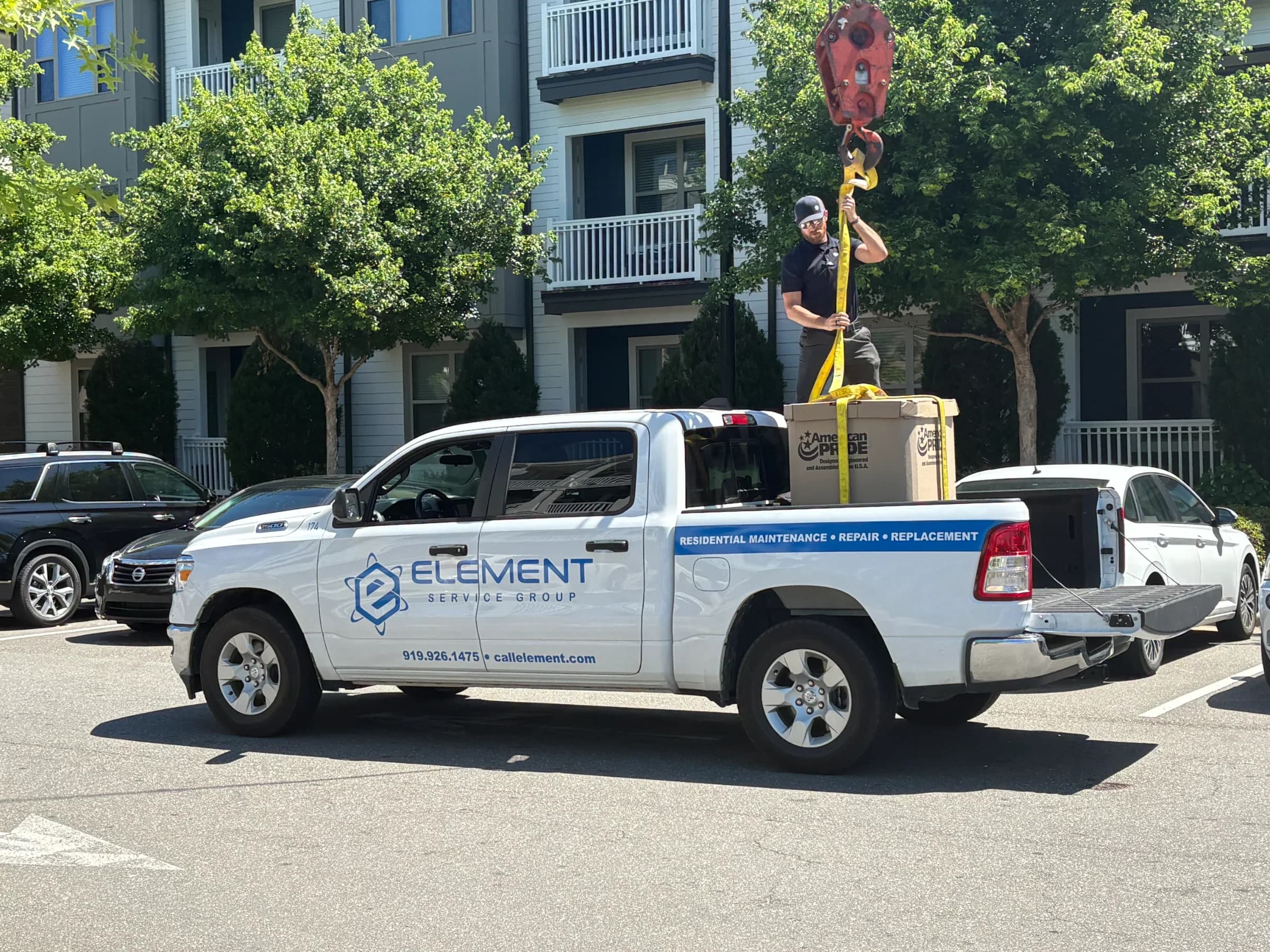 Element Service Group truck with technician handling equipment in residential area