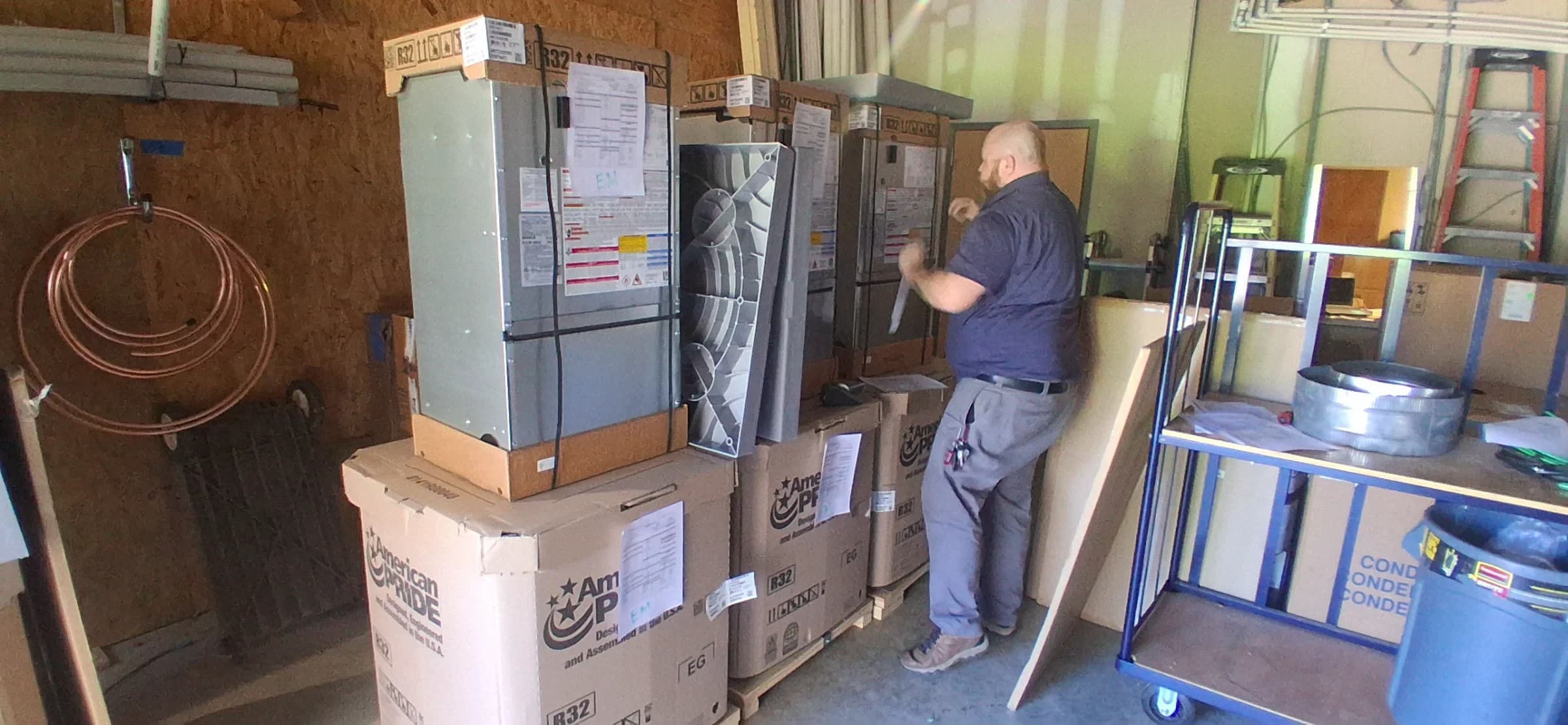 HVAC technician preparing new installation equipment for air conditioning services.