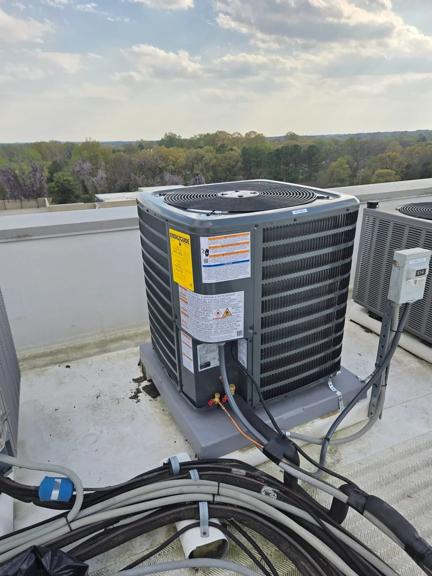 HVAC system AC repair on rooftop in Durham, showcasing air conditioning units and surroundings.