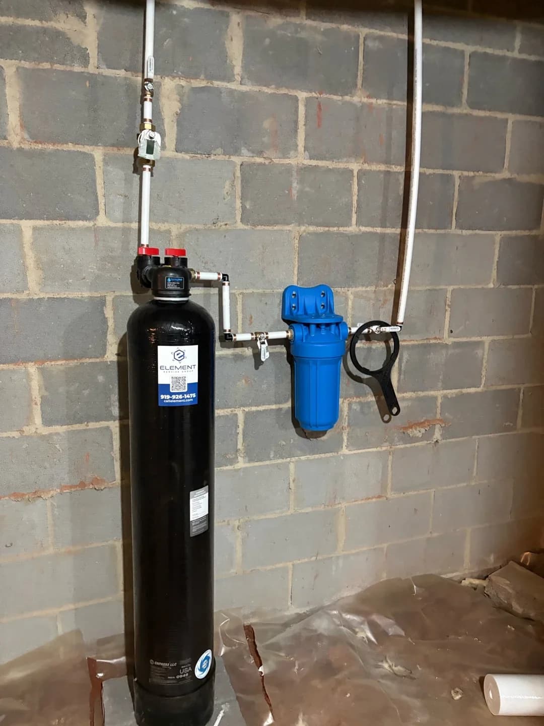 Water filtration system installation in a basement by an HVAC plumbing company